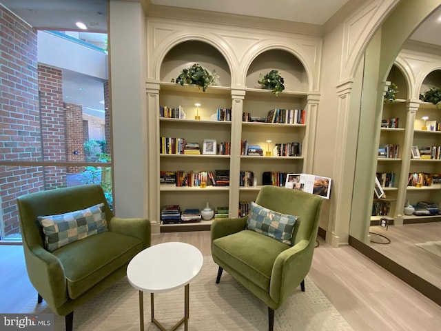 4808 Moorland Ln Unit 613, Bethesda, MD 20814 - living area featuring light wood-style flooring, built in features, and arched walkways