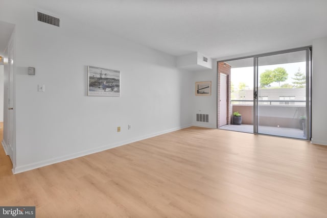 4808 Moorland Ln Unit 613, Bethesda, MD 20814 - spare room featuring light wood finished floors and expansive windows