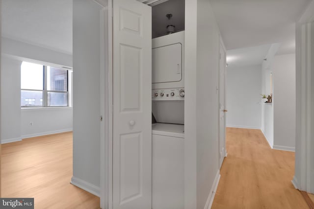 4808 Moorland Ln Unit 613, Bethesda, MD 20814 - washroom featuring estacked washer and dryer and light wood-style flooring