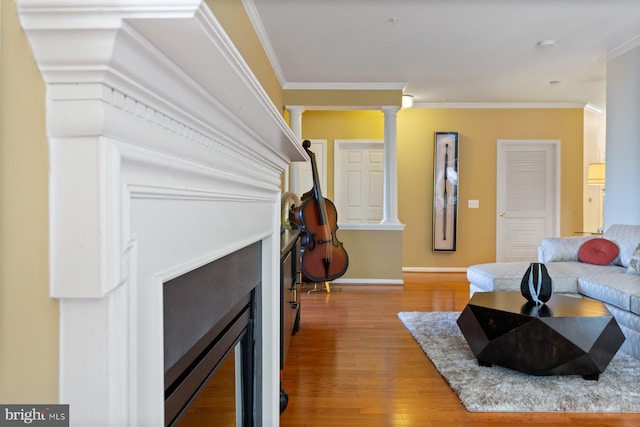 13801 Belle Chasse Blvd Unit 213, Laurel, MD 20707 - living room with crown molding, wood finished floors, ornate columns, and a fireplace