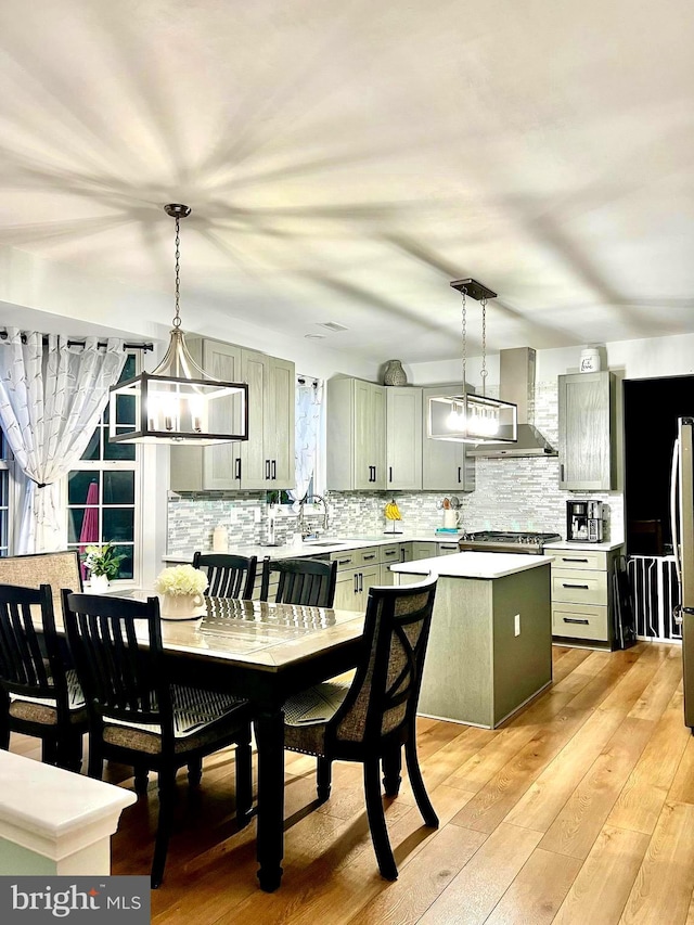 1411 Whispering Woods Ct, Williamstown, NJ 08094 - kitchen featuring light countertops, backsplash, a kitchen island, freestanding refrigerator, and light wood-type flooring