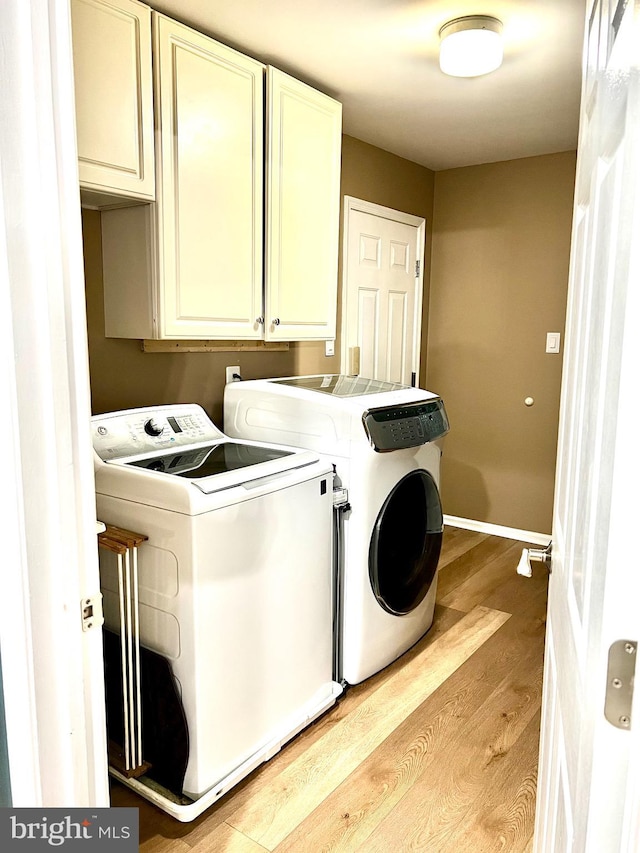 1411 Whispering Woods Ct, Williamstown, NJ 08094 - washroom with washer and clothes dryer, cabinet space, and light wood-type flooring