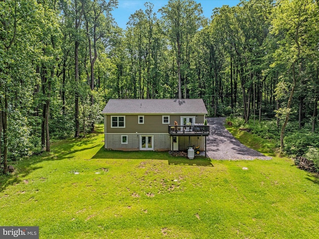 295 Rocky Mount Rd, Linden, VA 22642 - back of property featuring french doors, a deck, a lawn, and a wooded view