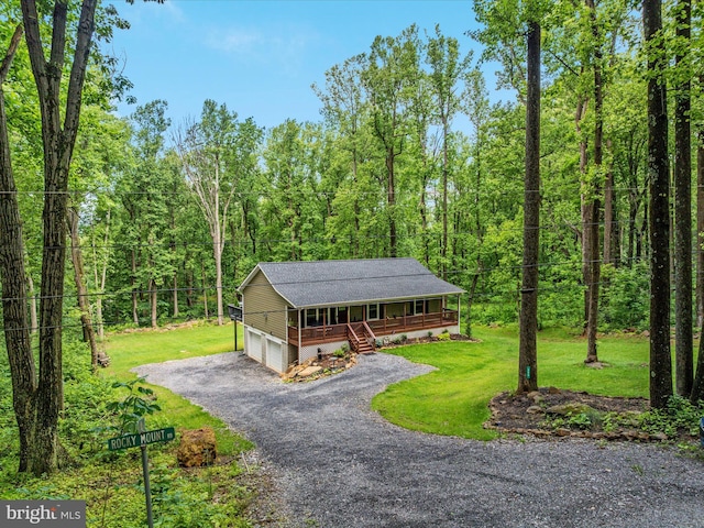 295 Rocky Mount Rd, Linden, VA 22642 - view of front of home with covered porch, a front lawn, a forest view, and a garage