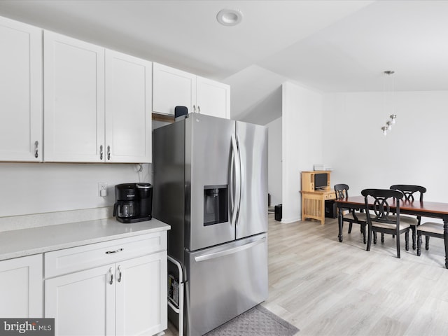295 Rocky Mount Rd, Linden, VA 22642 - kitchen with stainless steel fridge with ice dispenser, white cabinetry, light countertops, light wood-style flooring, and hanging light fixtures