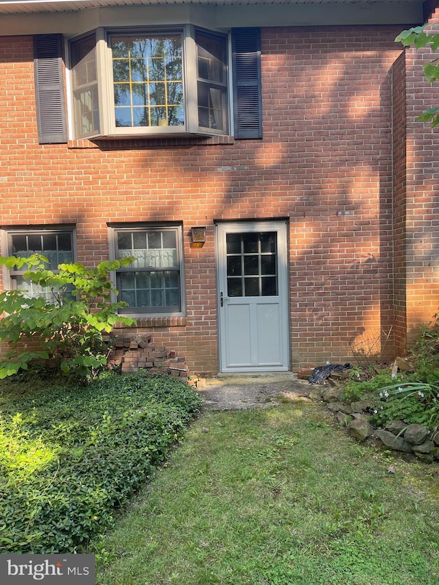 110 Linden Blvd, Middletown, MD 21769 - doorway to property with brick siding and a lawn