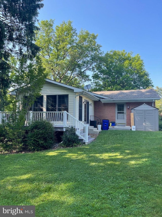 110 Linden Blvd, Middletown, MD 21769 - view of front of property with a shed, a front lawn, brick siding, and a sunroom