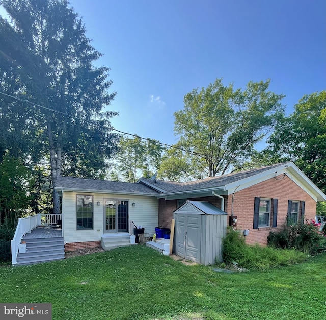 110 Linden Blvd, Middletown, MD 21769 - view of front of house featuring a storage unit, a wooden deck, a front lawn, and brick siding