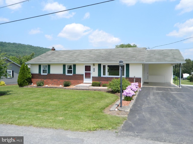 201 Cherry St, Millheim, PA 16854 - ranch-style house featuring brick siding, asphalt driveway, a front lawn, and a carport