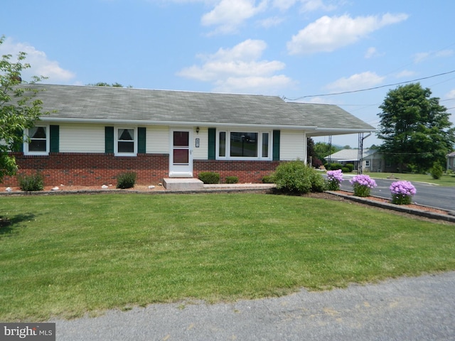 201 Cherry St, Millheim, PA 16854 - ranch-style home with brick siding, a front lawn, a carport, a shingled roof, and driveway