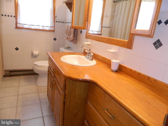 201 Cherry St, Millheim, PA 16854 - bathroom featuring plenty of natural light, a baseboard heating unit, tile walls, vanity, and decorative backsplash