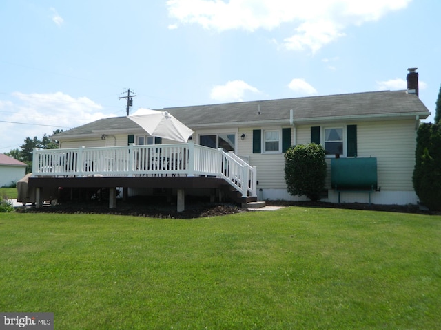 201 Cherry St, Millheim, PA 16854 - rear view of house with a deck, a lawn, oil tank, and a chimney