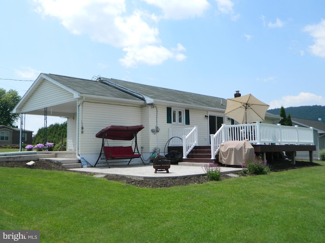 201 Cherry St, Millheim, PA 16854 - back of house featuring a lawn, a patio, a wooden deck, and an outdoor fire pit