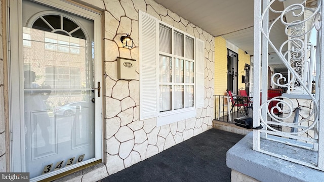 3436 D St, Philadelphia, PA 19134 - doorway to property featuring covered porch and stone siding