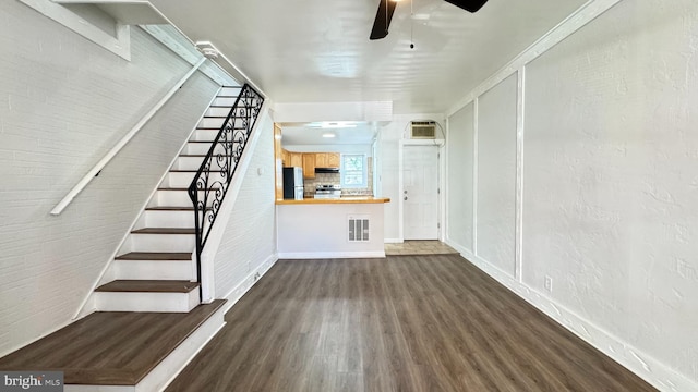 3436 D St, Philadelphia, PA 19134 - unfurnished living room featuring dark wood finished floors, stairway, and a ceiling fan