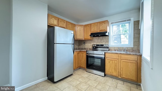 3436 D St, Philadelphia, PA 19134 - kitchen featuring appliances with stainless steel finishes, under cabinet range hood, backsplash, and light tile patterned flooring