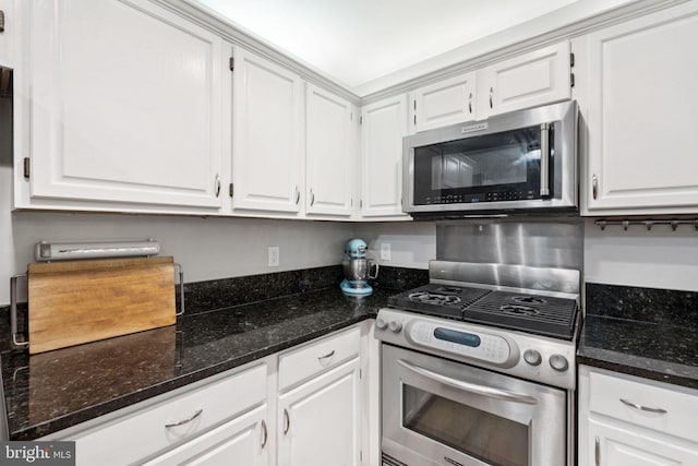 11736 Rockaway Ln Unit 101, Fairfax, VA 22030 - kitchen featuring appliances with stainless steel finishes, white cabinets, and dark stone countertops