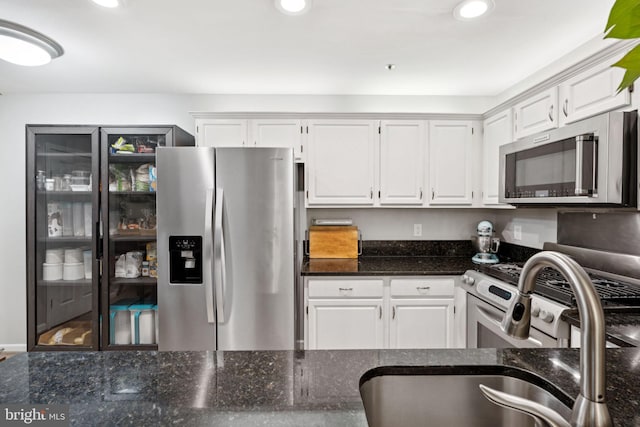11736 Rockaway Ln Unit 101, Fairfax, VA 22030 - kitchen featuring appliances with stainless steel finishes, white cabinetry, dark stone counters, and recessed lighting