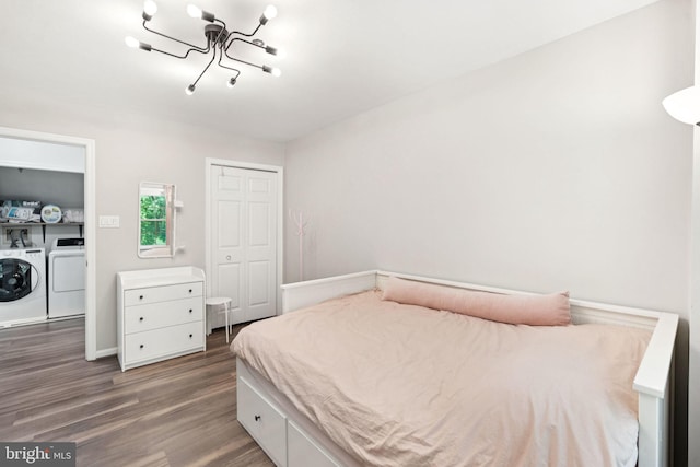 11736 Rockaway Ln Unit 101, Fairfax, VA 22030 - bedroom with separate washer and dryer, wood finished floors, a closet, and a chandelier
