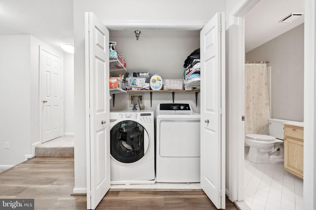 11736 Rockaway Ln Unit 101, Fairfax, VA 22030 - laundry area with washer and clothes dryer and wood finished floors