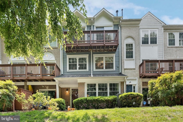11736 Rockaway Ln Unit 101, Fairfax, VA 22030 - rear view of house with a balcony, brick siding, and a yard