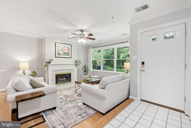 11736 Rockaway Ln Unit 101, Fairfax, VA 22030 - living area featuring crown molding, a ceiling fan, a high end fireplace, and light wood-style floors