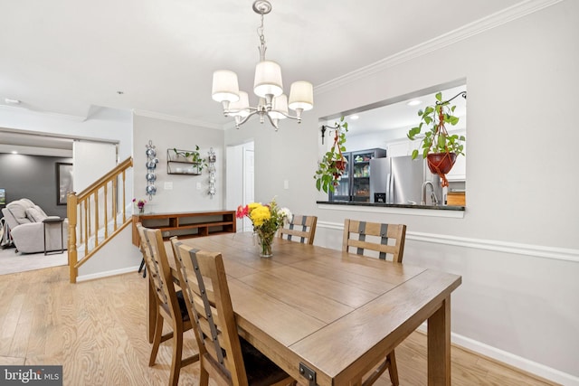 11736 Rockaway Ln Unit 101, Fairfax, VA 22030 - dining room with light wood-type flooring, a chandelier, ornamental molding, and stairway