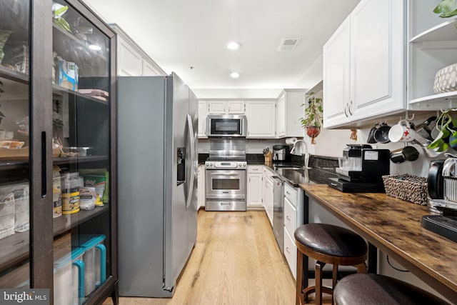 11736 Rockaway Ln Unit 101, Fairfax, VA 22030 - kitchen featuring stainless steel appliances, light wood-style floors, white cabinetry, butcher block countertops, and recessed lighting