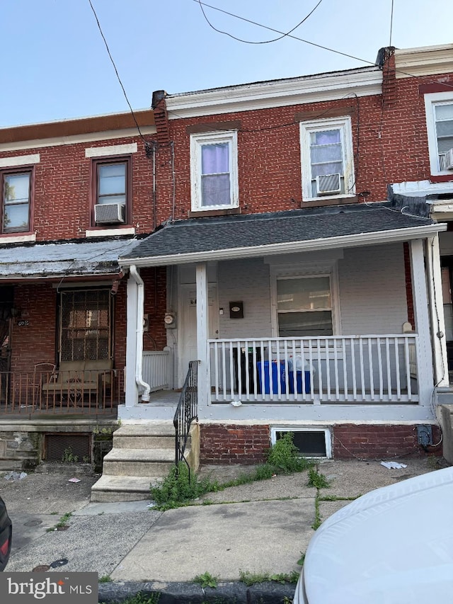 6018 Magnolia St, Philadelphia, PA 19144 - townhome / multi-family property featuring a porch, brick siding, and cooling unit