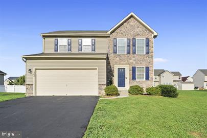 362 Harvest Grove Trl, Dover, DE 19901 - view of front of house with stone siding, an attached garage, a front lawn, and asphalt driveway