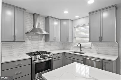 362 Harvest Grove Trl, Dover, DE 19901 - kitchen with gray cabinetry, appliances with stainless steel finishes, wall chimney range hood, backsplash, and recessed lighting