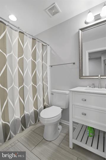 362 Harvest Grove Trl, Dover, DE 19901 - bathroom featuring vanity, wood tiled floors, and a shower with curtain