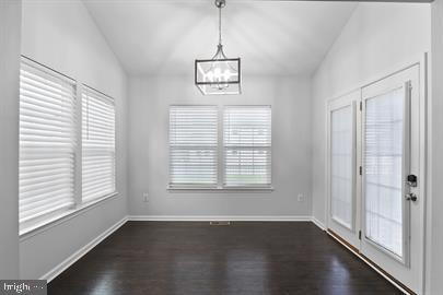 362 Harvest Grove Trl, Dover, DE 19901 - unfurnished dining area with a chandelier, dark wood finished floors, healthy amount of natural light, and vaulted ceiling