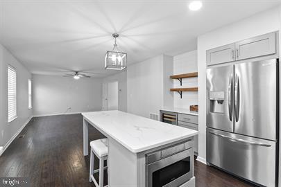 362 Harvest Grove Trl, Dover, DE 19901 - kitchen with appliances with stainless steel finishes, dark wood-style floors, open shelves, gray cabinets, and ceiling fan