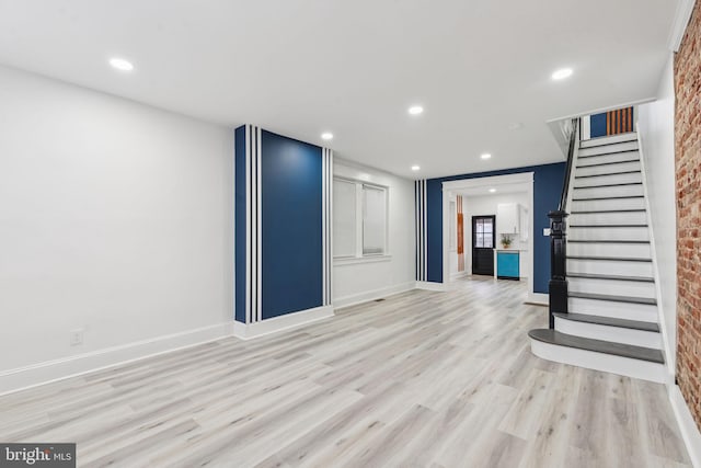 3287 Edgemont St, Philadelphia, PA 19134 - unfurnished living room featuring light wood finished floors, stairs, recessed lighting, and brick wall