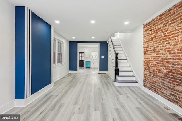 3287 Edgemont St, Philadelphia, PA 19134 - unfurnished living room featuring brick wall, light wood-type flooring, stairway, and recessed lighting