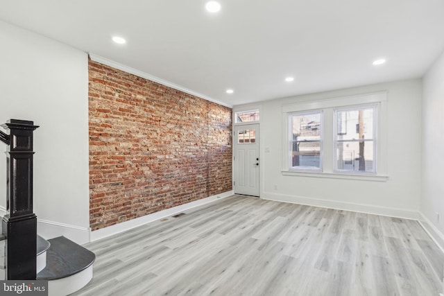 3287 Edgemont St, Philadelphia, PA 19134 - unfurnished living room featuring brick wall, light wood-style floors, and recessed lighting