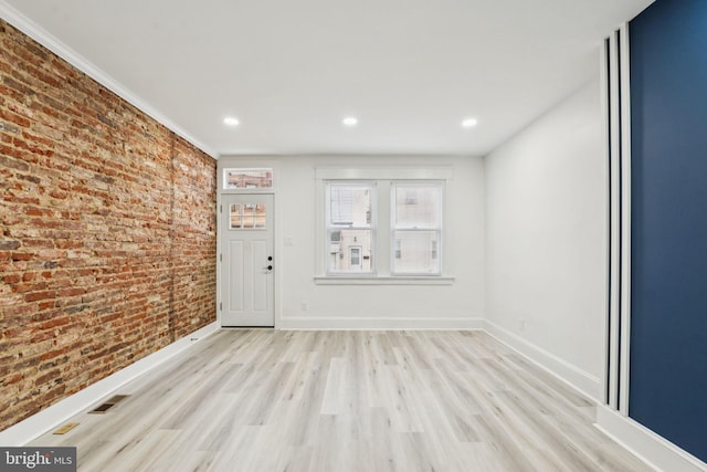 3287 Edgemont St, Philadelphia, PA 19134 - unfurnished room featuring light wood finished floors, brick wall, and recessed lighting