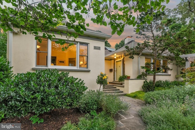 7001 Sycamore Ave, Takoma Park, MD 20912 - view of front of home with stucco siding and a chimney