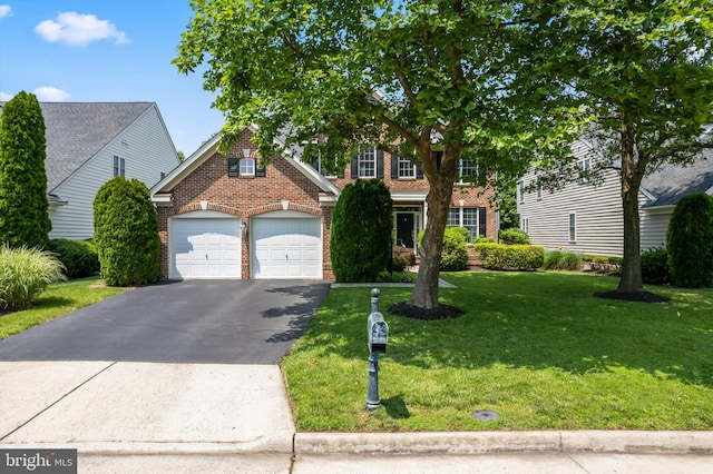 42066 Fiddlehead Pl, Aldie, VA 20105 - traditional home with brick siding, asphalt driveway, a front lawn, and a garage