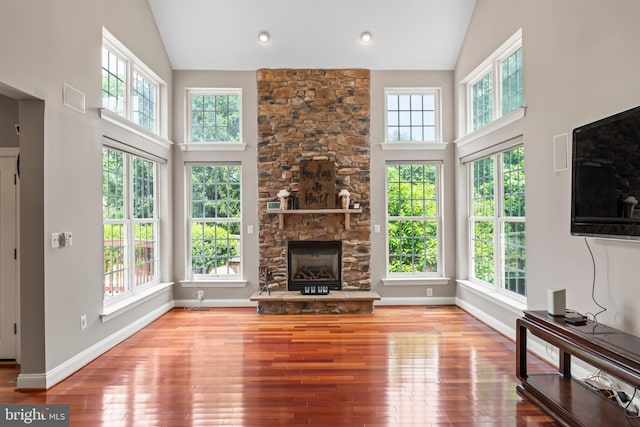42066 Fiddlehead Pl, Aldie, VA 20105 - unfurnished living room featuring plenty of natural light, high vaulted ceiling, wood finished floors, and a fireplace