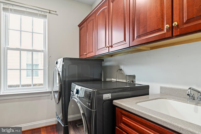 42066 Fiddlehead Pl, Aldie, VA 20105 - washroom with washer and dryer, cabinet space, and wood finished floors