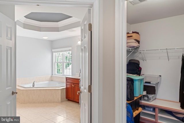 42066 Fiddlehead Pl, Aldie, VA 20105 - bathroom featuring a bath, vanity, tile patterned flooring, a raised ceiling, and a walk in closet