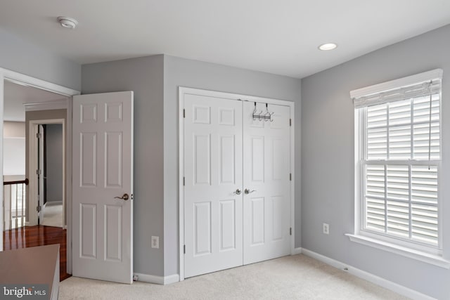 42066 Fiddlehead Pl, Aldie, VA 20105 - unfurnished bedroom with light colored carpet, a closet, multiple windows, and recessed lighting