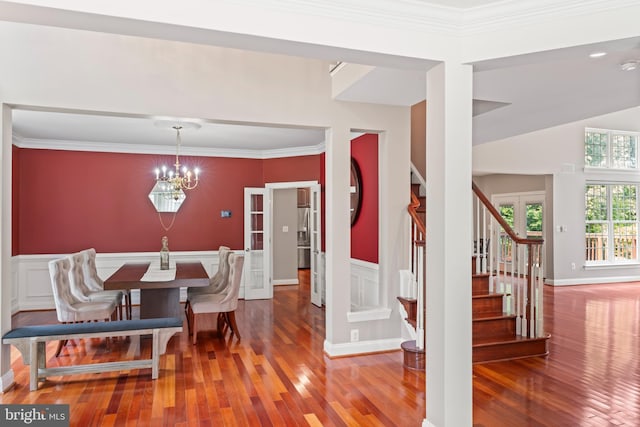 42066 Fiddlehead Pl, Aldie, VA 20105 - dining area featuring wood finished floors, stairs, a chandelier, and ornamental molding