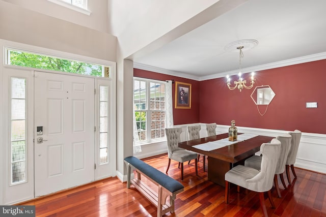 42066 Fiddlehead Pl, Aldie, VA 20105 - dining area featuring hardwood / wood-style floors, a chandelier, healthy amount of natural light, crown molding, and a wainscoted wall