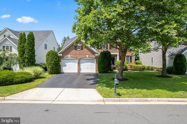 42066 Fiddlehead Pl, Aldie, VA 20105 - view of front of home featuring brick siding, driveway, a front yard, and a garage