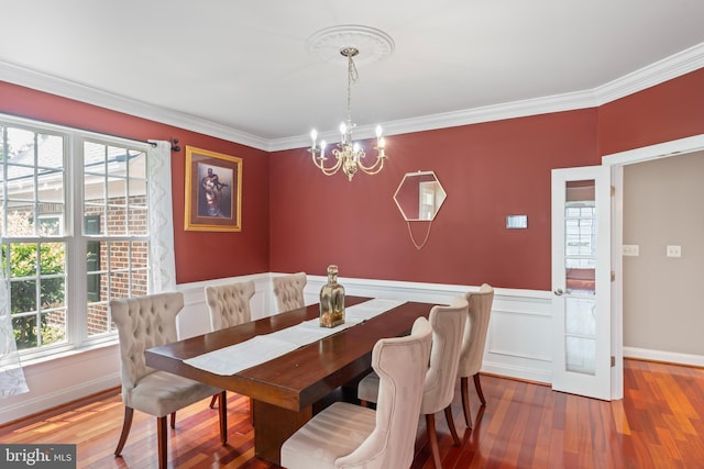 42066 Fiddlehead Pl, Aldie, VA 20105 - dining area with a chandelier, plenty of natural light, ornamental molding, wood finished floors, and wainscoting