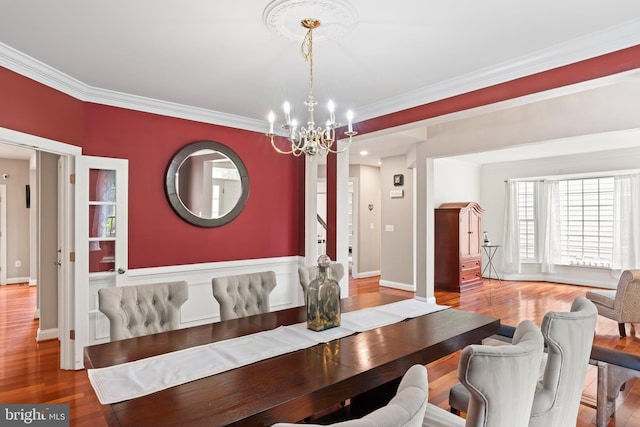 42066 Fiddlehead Pl, Aldie, VA 20105 - dining room featuring a chandelier, wood finished floors, and crown molding
