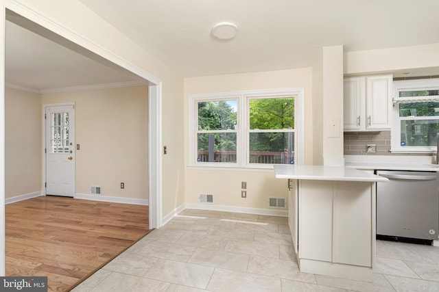 76 Stonicker Dr, Lawrence, NJ 08648 - kitchen with stainless steel dishwasher, healthy amount of natural light, light countertops, crown molding, and white cabinetry